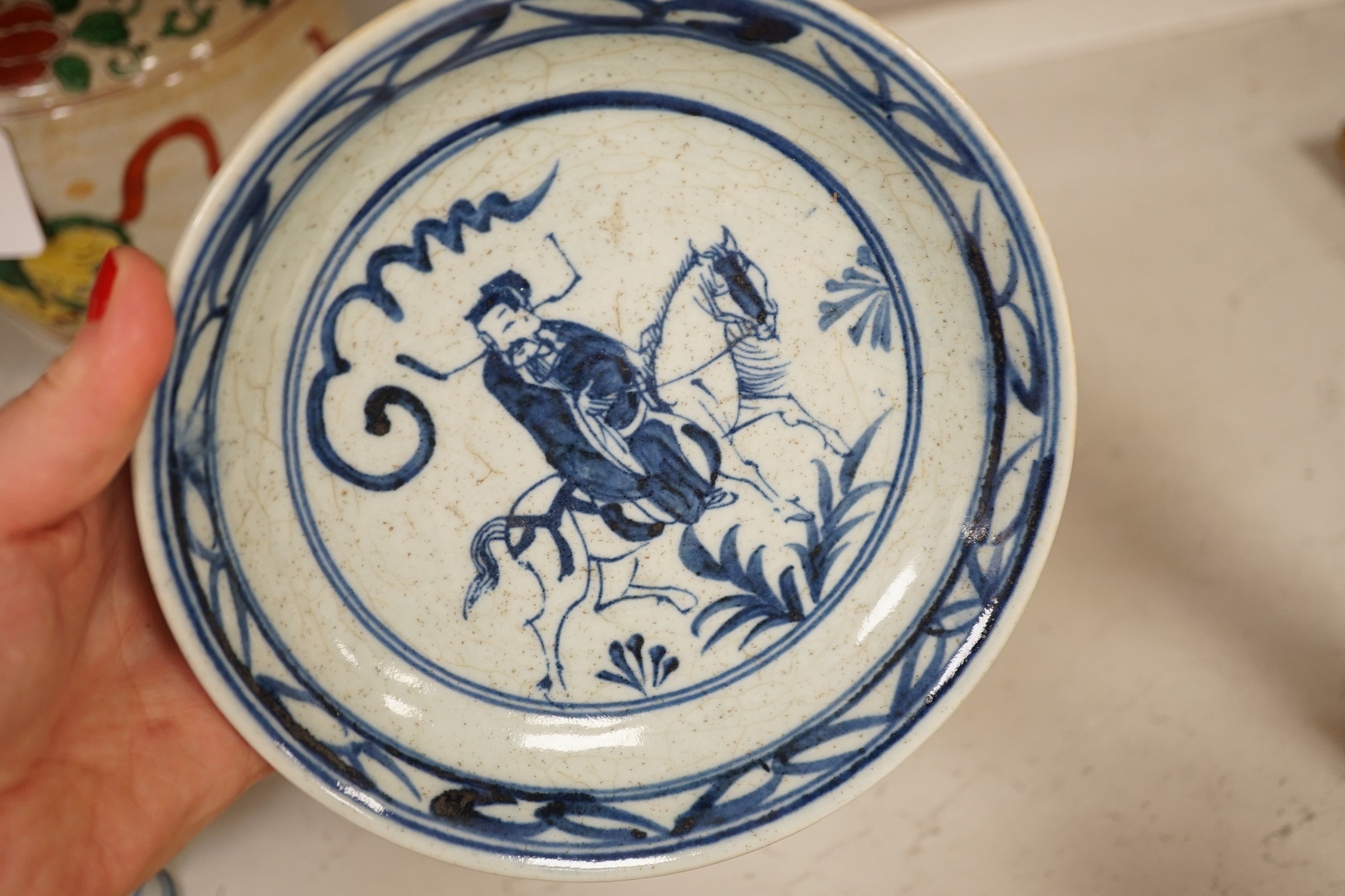 A Chinese wucai vase, two Imari bowls, a pair of Chinese blue and white dragon stem cups, Xuande marks, a Chinese blue and white dish, depicting a scholar on horseback, Xuande mark, a small green Chinese bowl, painted wi